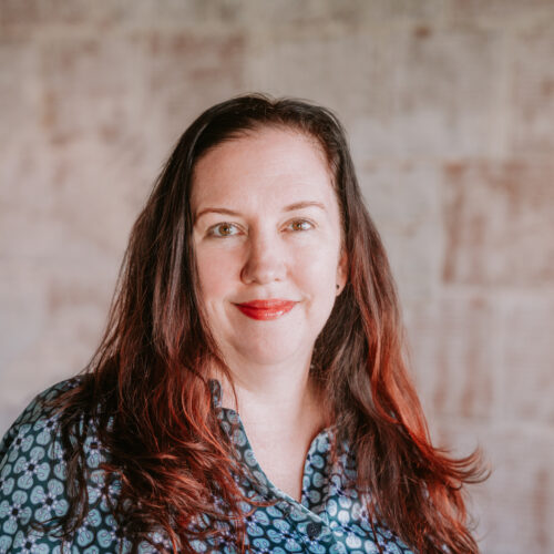 Erika Heald is wearing a navy and white patterned shirt.