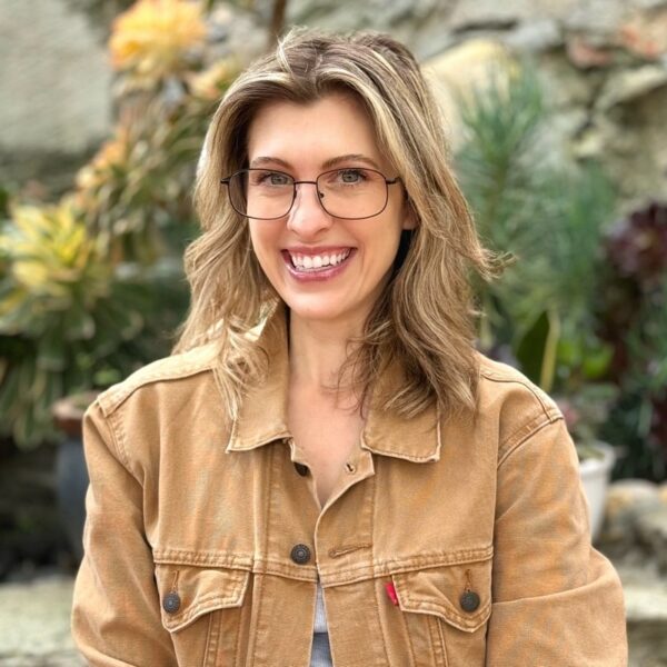 Heike Young is wearing glasses and wearing a tan jean jacket.